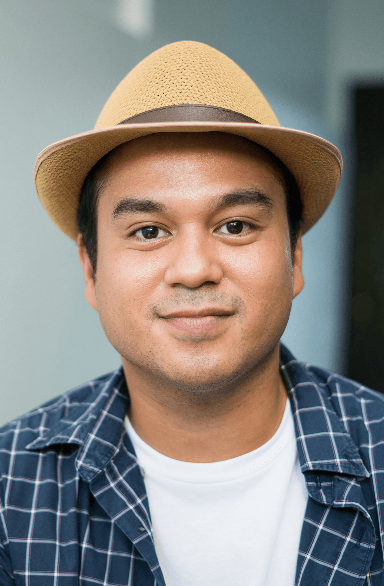 A hispanic male adult smiling looking directly in the camera
